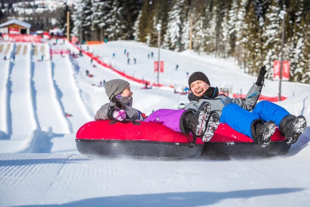 Father and Daughter snow tubing in Whistler