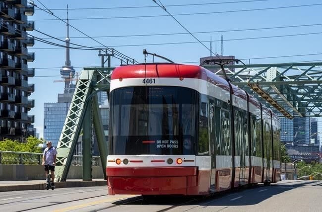 a ttc street car with cn tower background